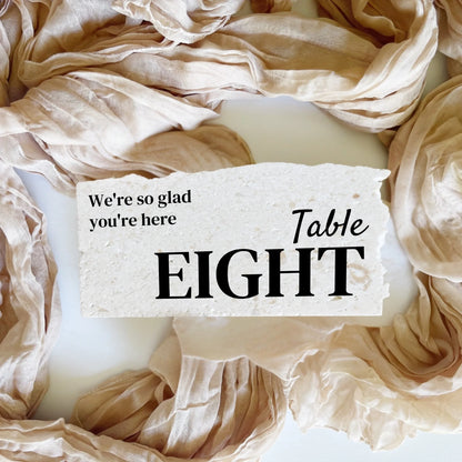 Limestone stone table number eight in landscape orientation, handcrafted with black typography for wedding or event décor.