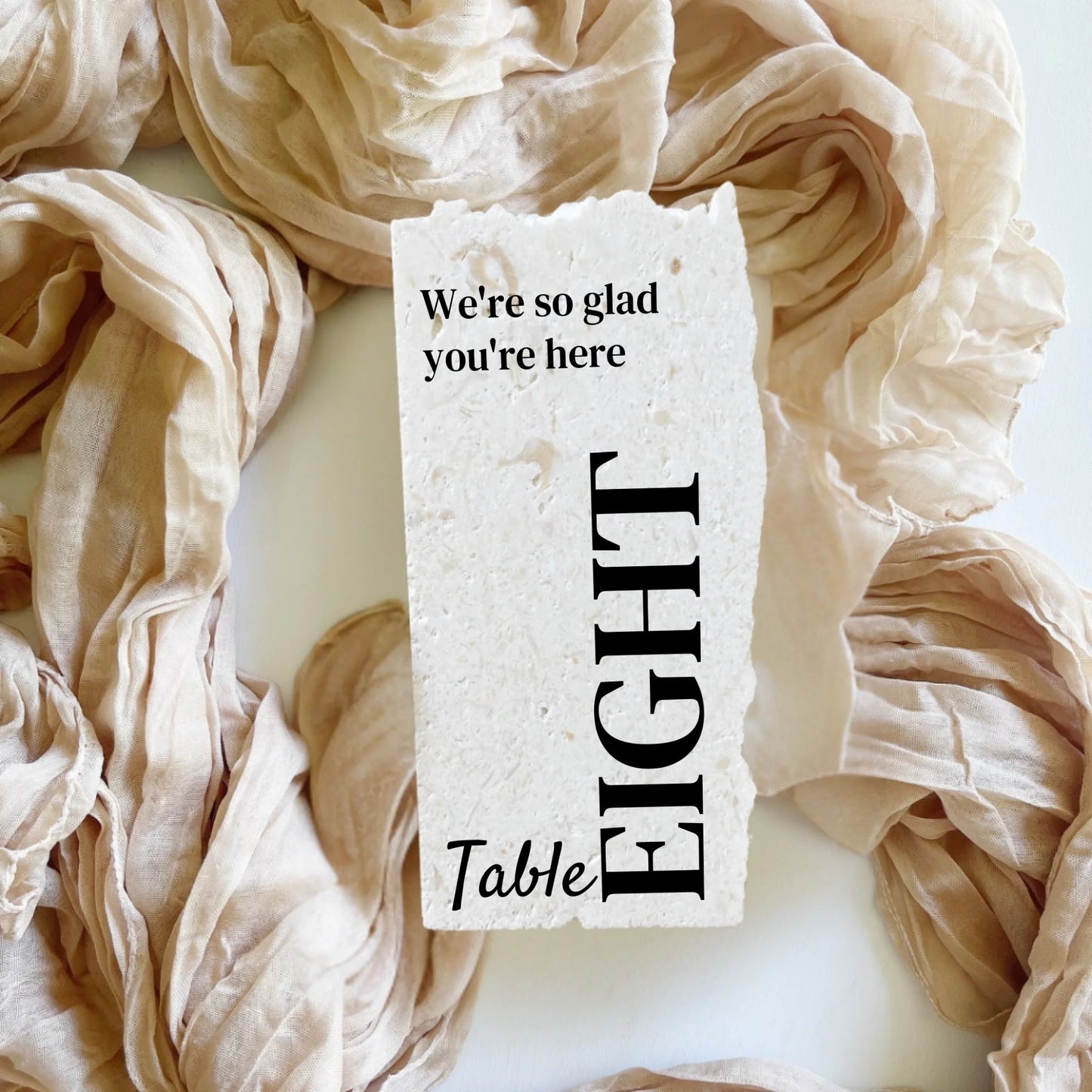 Limestone stone table number eight in portrait format, elegant design with natural stone texture, styled for weddings.